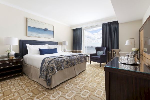 A well-appointed hotel room with a plush bed, elegant decor, and a view.