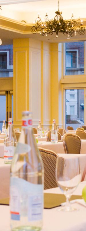 An elegant banquet hall with set tables, ready for an event.