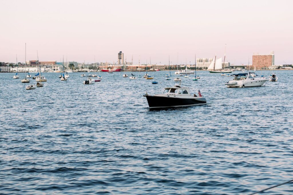 The image shows numerous boats floating on a body of water near a cityscape with various buildings and structures visible in the background, ending the sentence.