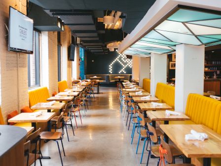 Rows of tables and chairs in a restaurant