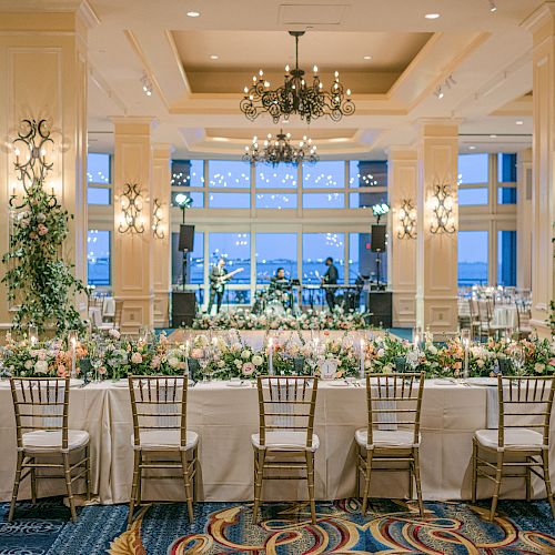 Elegant banquet hall set for an event with decorated tables and chairs.