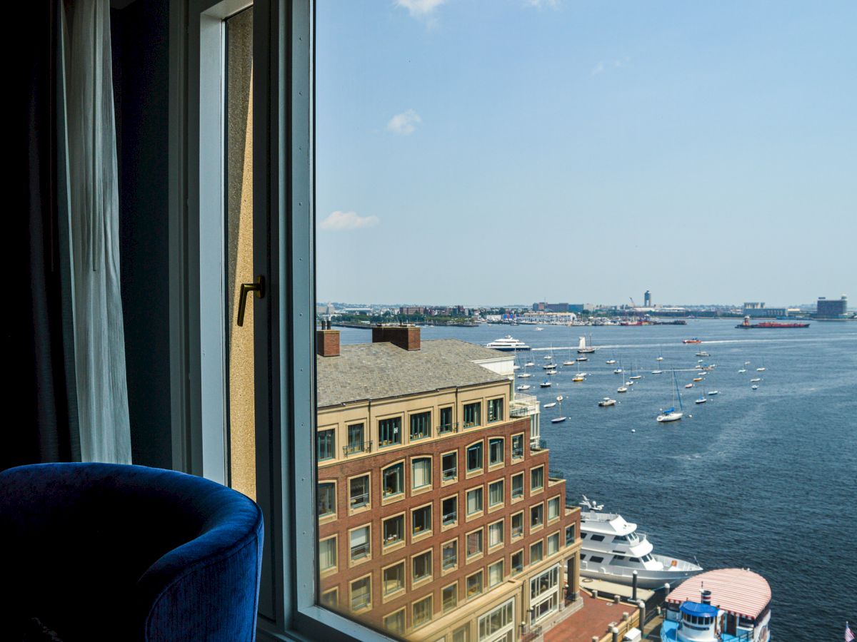 A harbor view with boats, buildings, and a dome structure near the water.